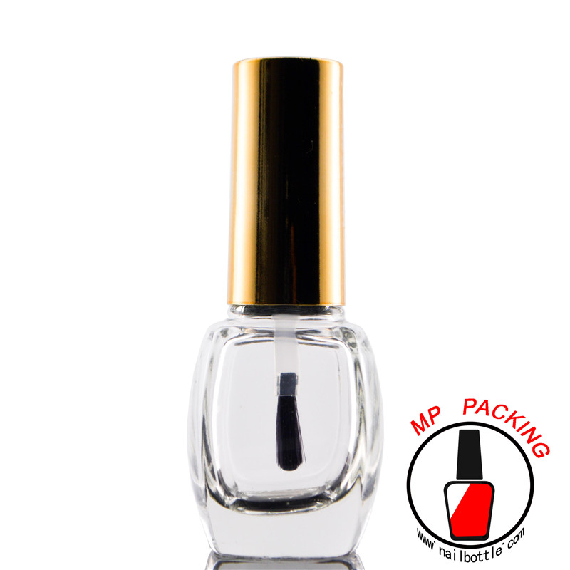 empty nail polish bottle with gold cap and oval brush